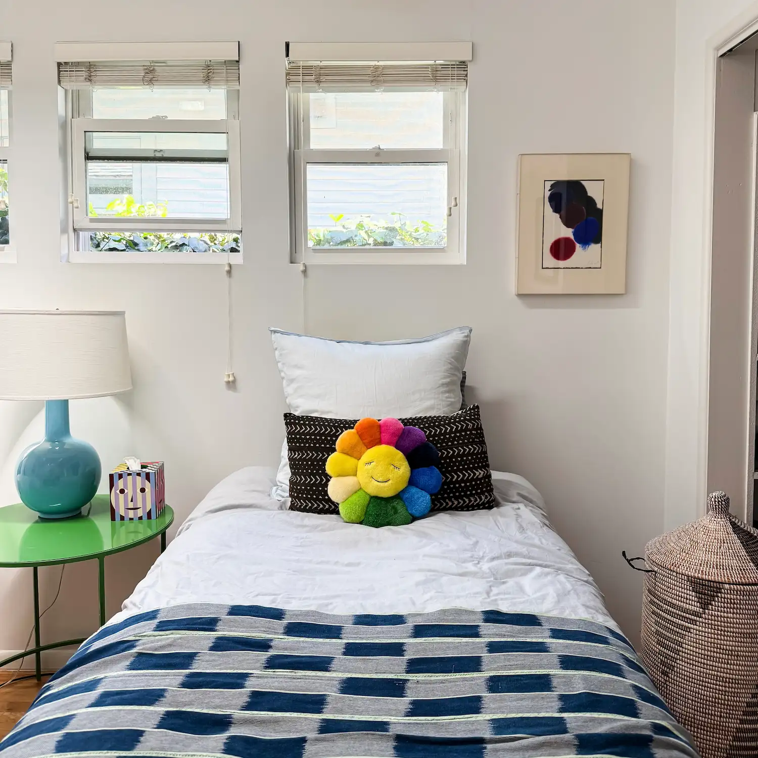 bedroom with blue walls and painting