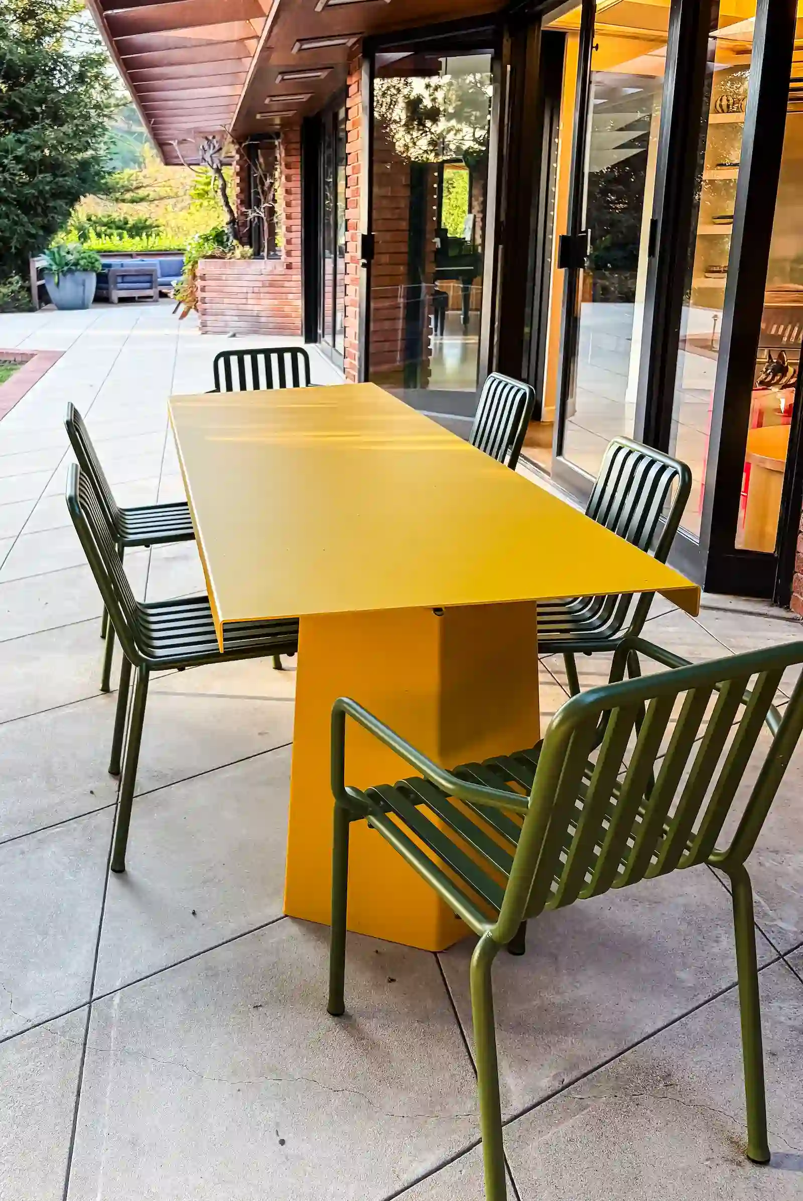yellow outdoor table and green chairs